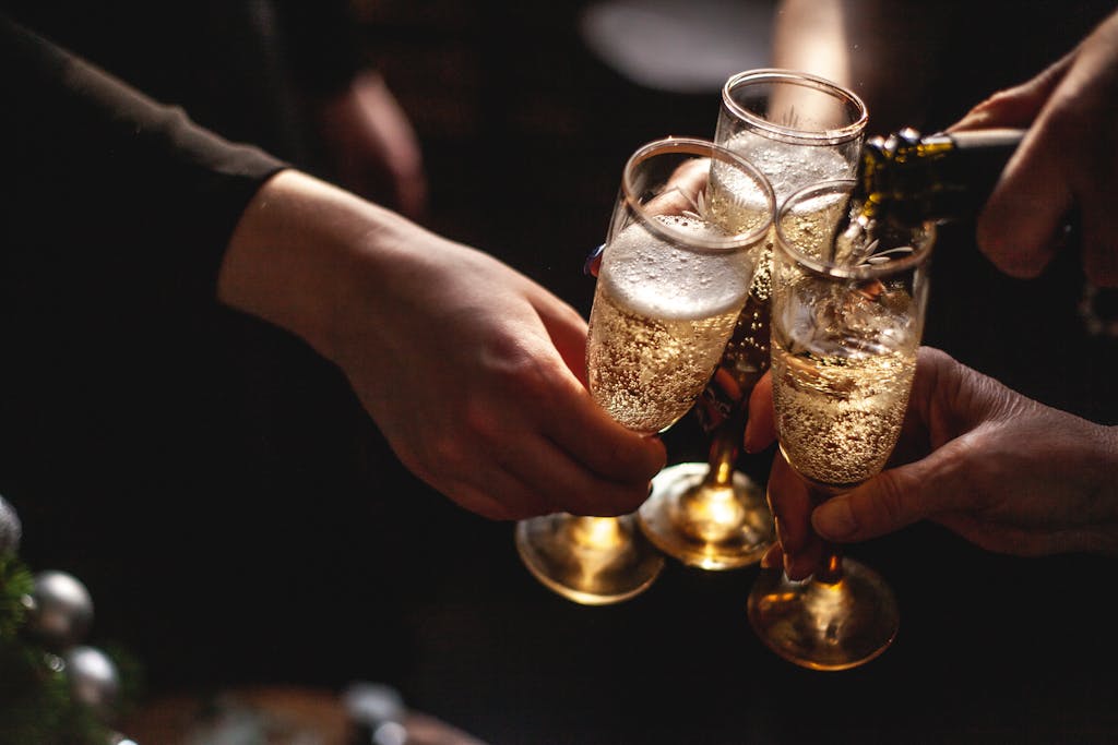 People Holding Champagne Glasses